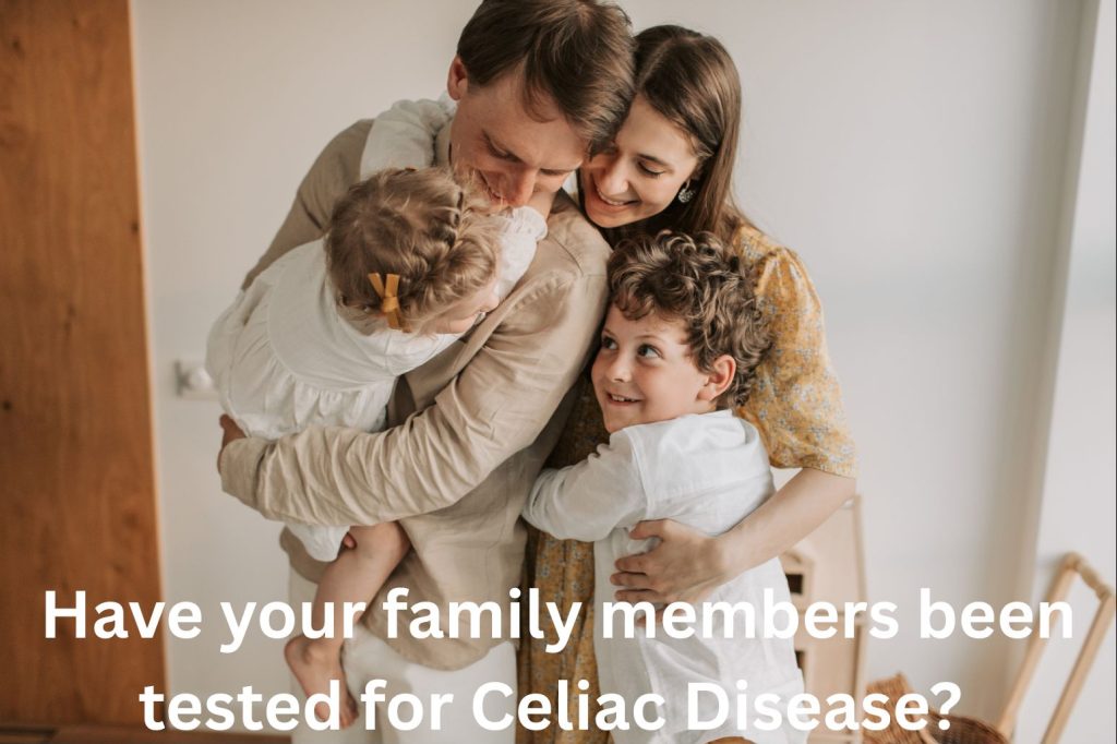 Family of two parents embracing their two young children.