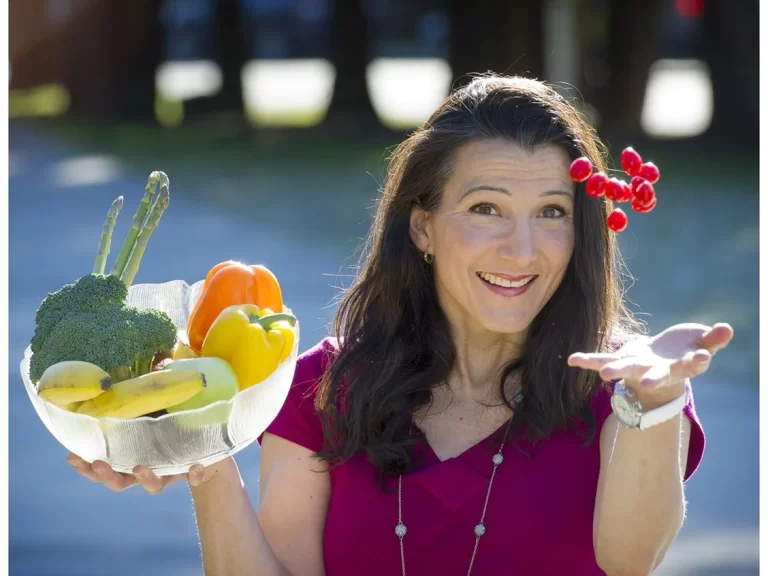 cristina sutter holding a bowl of vegetables and catching fruit mid air
