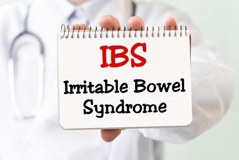 doctor holding notepad with IBS Irritable Bowel Syndrome written on it