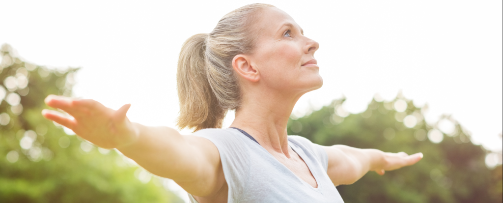 middle aged woman stretching outside